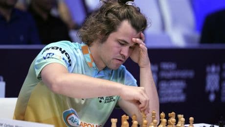 Chess grandmaster Magnus Carlsen is forced into a draw in a showdown against 'the world'