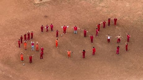 Inmates awaiting deportation make giant ‘SOS’ message with their bodies that can be seen from the skies