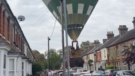 Moment hot air balloon lands on street in front of stunned residents