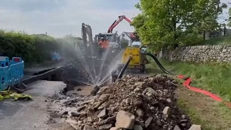 Huge sinkhole suddenly emerges in road leaving locals without water after burst pipe