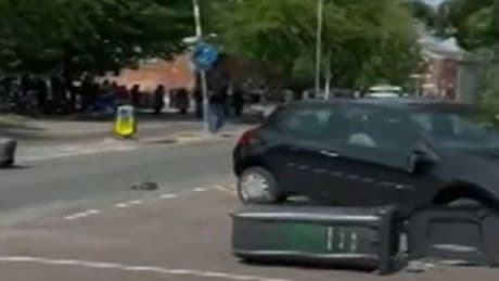 Salford riots: Teenage girl arrested after violence erupts and car set on fire