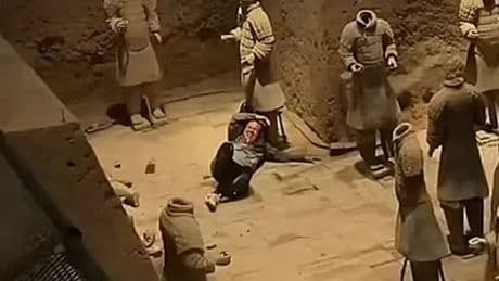Shock moment tourist jumps railing and plunges 18ft into Terracotta Army pit before smashing two priceless statues
