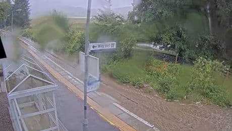 Torrential rain floods Scots roads as driver stranded and rail lines hit by closures