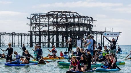 Thousands turn out for paddle out protests over ‘sewage scandal’