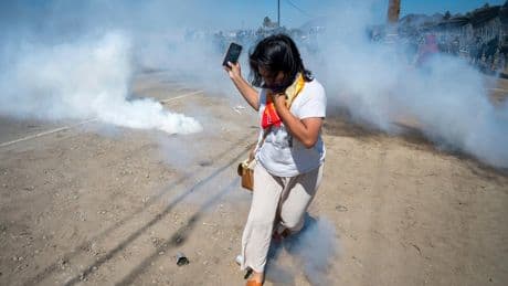 Photos of a confrontation between protesters and federal officials outside California farm