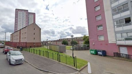 Woman arrested after man's body found at Glasgow flats
