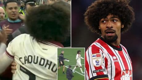 Sheffield United star has to be held back as rival players clash during pitch invasion - after Burnley are promoted back to the Premier League