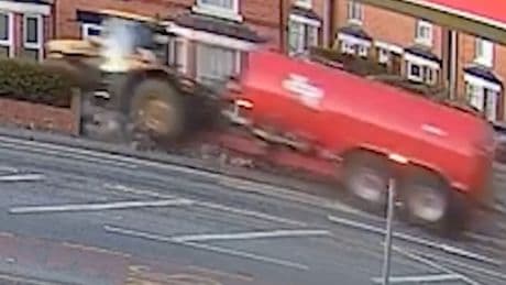Moment tractor smashes into homes after drug driver runs red light