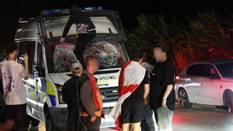 Protesters clash with police outside hotel believed to house asylum seekers