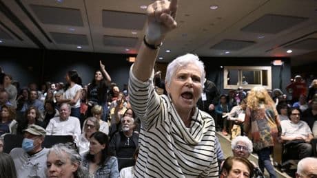 A GOP congressman is peppered with questions about Trump during raucous town hall