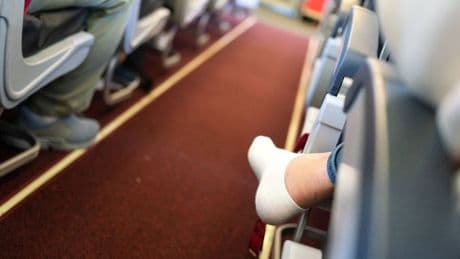 Flight attendant says travellers should never remove their shoes after take-off