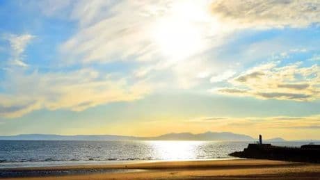 Woman on inflatable crocodile and teens on mattress blown out to sea on Scots beach