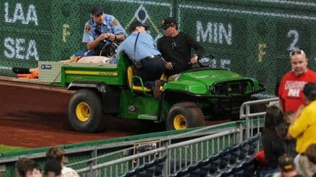 Horrifying moment fan falls from 21-foot wall at Major League Baseball game as players pray and hold crosses