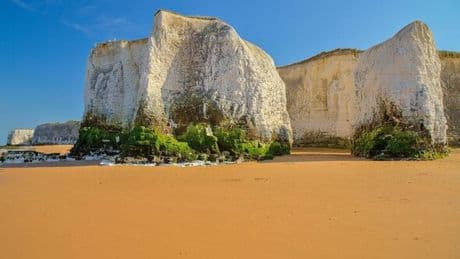 Beautiful secluded bay with golden sandy beach between 2 best seaside towns