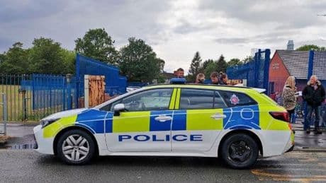 Armed cops swarm Manchester street as school locks down amid 'man with knife' reports