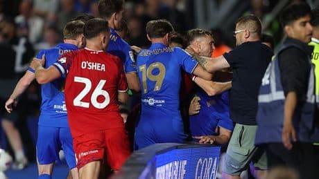 Shocking moment football thug tries to FIGHT opposition players during ugly brawl on opening game of the season - before being flatlined by security