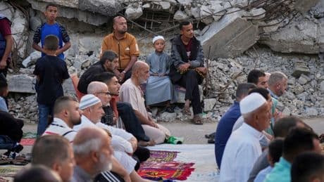 Gazans pray in rubble at start of Eid - as Israel warns of intensive new military operations