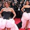 Halle Berry flouts the Cannes Film Festival's strict new dress code as she hits the red carpet in a voluminous black-and-pink gown at Mission: Impossible premiere