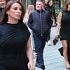Coleen Rooney cuts a glamorous figure in a leggy black dress as she enjoys a night out in Manchester with husband Wayne