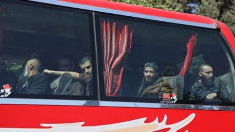 Syrian government and Kurdish-led force exchange prisoners in a step toward easing tensions