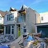Couple whose home was demolished by 'Britain's worst builder' while they were on holiday in a row over money finally get to move into property