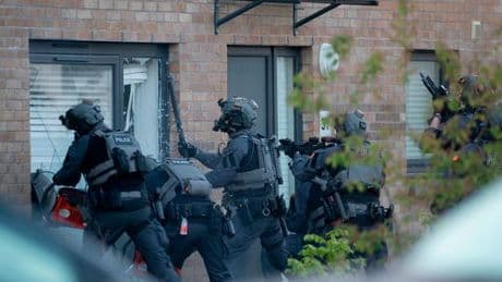 Gang war cops storm Glasgow home and seize two suspects in series of dramatic dawn raids