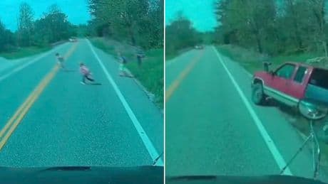 Moment overtaking pick-up truck narrowly misses children getting off school bus