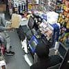 Terrifying moment balaclava-clad robber threatens shop worker with meat cleaver before stealing £2,000 - as police launch manhunt