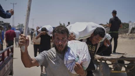 Palestinians say Israel and its allies fired on a crowd near Gaza aid site. Hospital says 14 killed