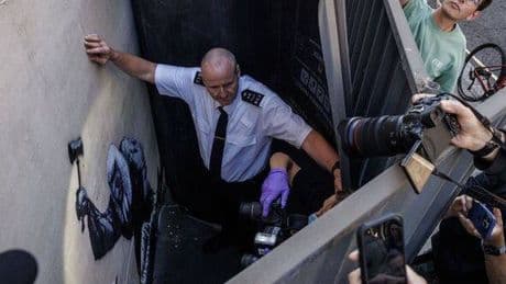 Banksy mystery could be solved as police probe new court protest graffiti that could UNMASK him
