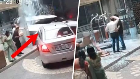 Auto ramt hotel: vrouw rijdt achteruit glazen ingang in