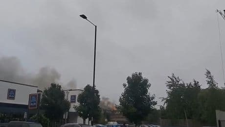 Blaze erupts at ‘retirement property’ with smoke billowing into sky as firefighters rush to 4-storey block of flats