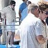 Sir Elton John is assisted off a boat in Italy before enjoying Al fresco meal with husband David Furnish after seemingly picking a side in Beckham family feud