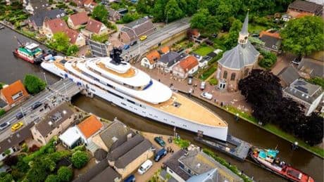 Ex-Starbucks CEO billionaire's mega yacht spotted travelling through village's tiny canal