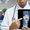 NHS launches review after more than 10,000 knee replacement patients were fitted with a potentially faulty implant that left many immobile and addicted to painkillers