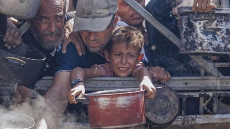 Children 'eating out of piles of garbage' as Gaza aid trickles in