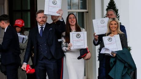 Influencer who was photographed celebrating with a binder of Epstein documents is now ripping into his victims