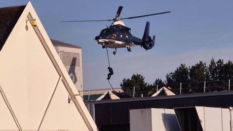 Building close to Tesco stormed by masked figures who drop from helicopters