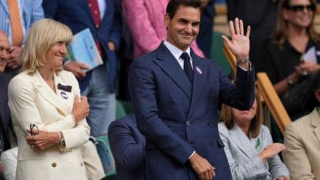 Roger Federer sits in Wimbledon's Royal Box to watch rival Novak Djokovic win