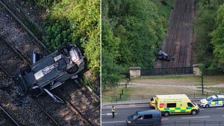 Pensioner dies after car crashes down embankment onto railway