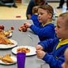 Rollout of free breakfast clubs to begin this week for 750 schools - amid funding row as critics plead with government to be 'more realistic'