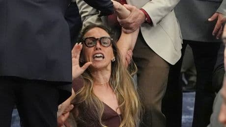 Shocking scenes as woman dragged out of meeting for trying to speak during hearing on ICE rules