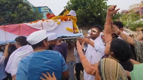Air India crash survivor carries coffin of brother killed in disaster