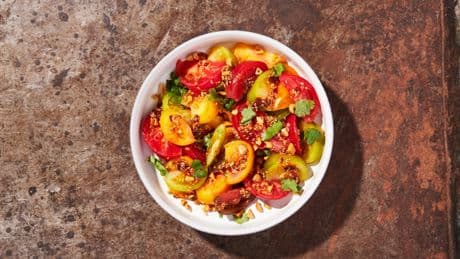Savory-spicy peanut dressing complements the sweetness of this tomato salad