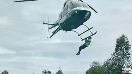 Watch bizarre moment man clings to helicopter as it takes off at lavish wedding after ‘begging for a ride’