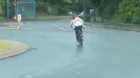 Shocking moment cyclist tears through traffic with child clinging to back – before riding WRONG way through roundabout