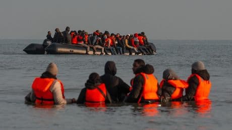 Scores of migrants board overloaded dinghies to make dangerous Channel crossing to UK – as French cops watch on