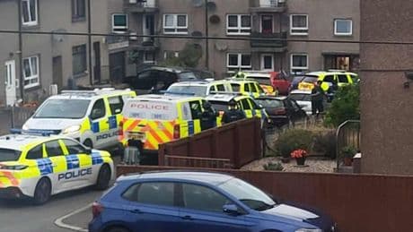 Armed police swarm Scots street and storm home arresting two in early morning raid