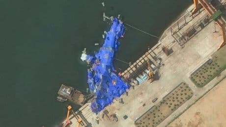 Satellite images show the catastrophic damage to North Korea's new destroyer that's lying on its side