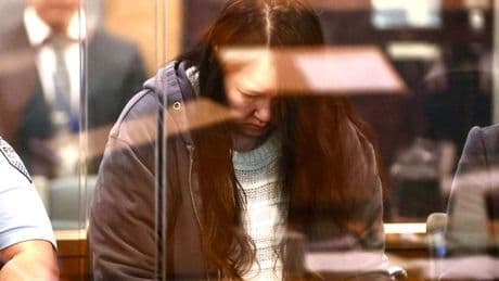 Mum shakes head as she faces trial for killing kids and storing bodies in suitcases